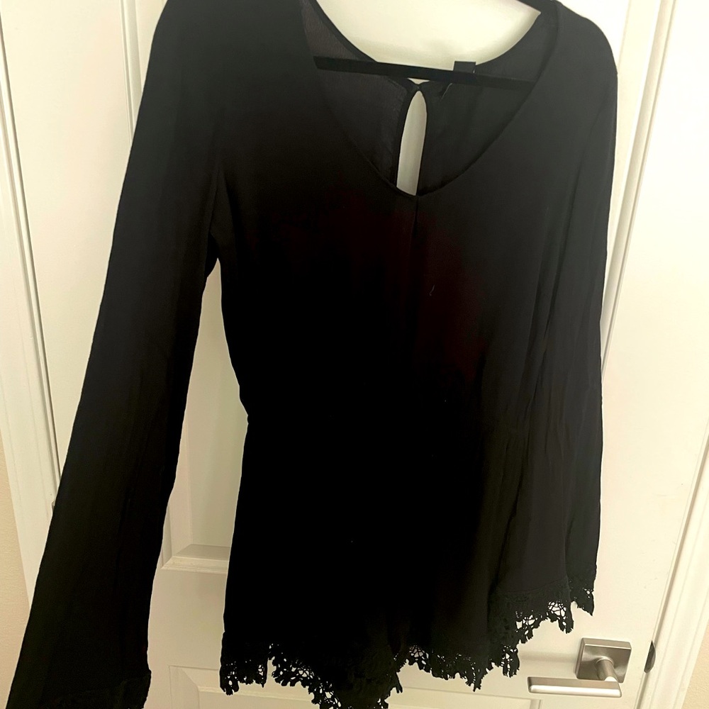 Black romper w/ lace details and bell style sleeve